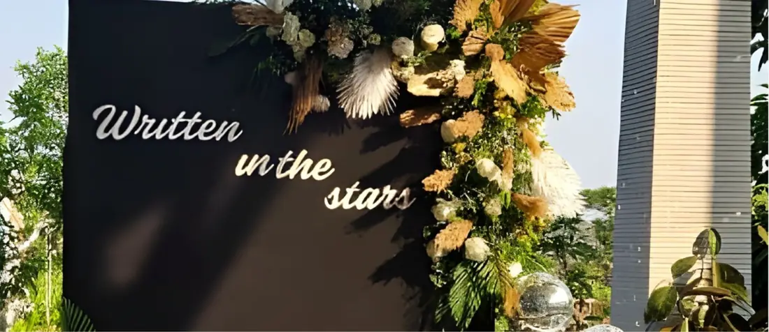 Floral entrance with 'Written in the stars' signage